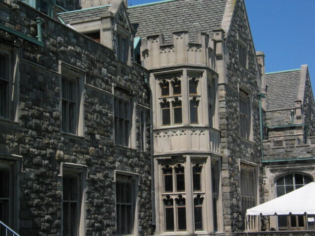 Ornate windows on a stone building.