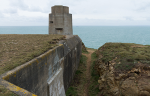 A concrete structure with a walkway down the side.