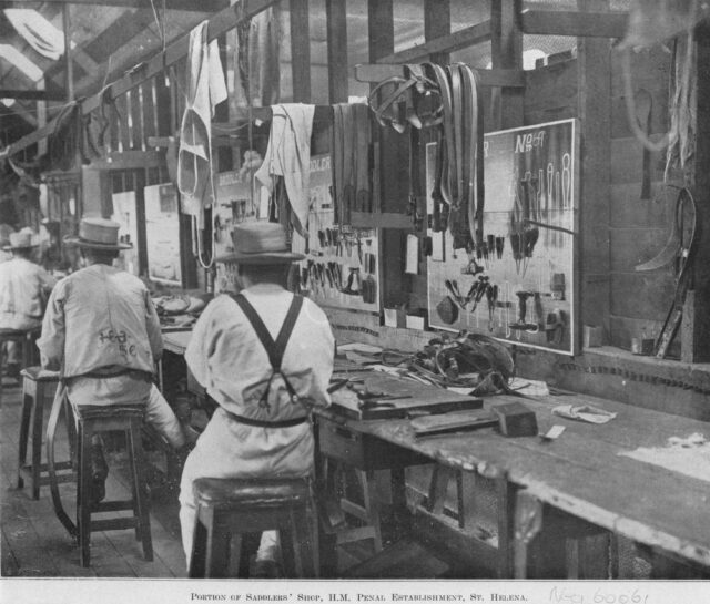 Men working at tables building saddles.
