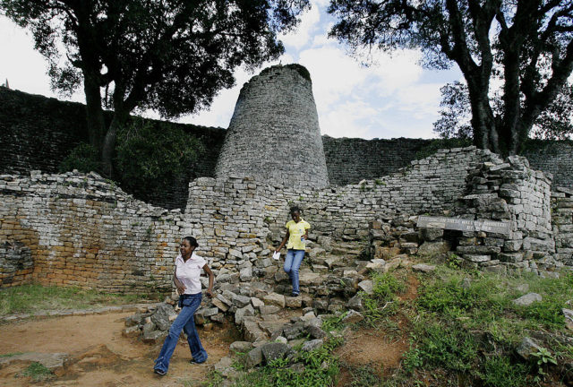 Tourists explore the ruins of Great Zimbabwe