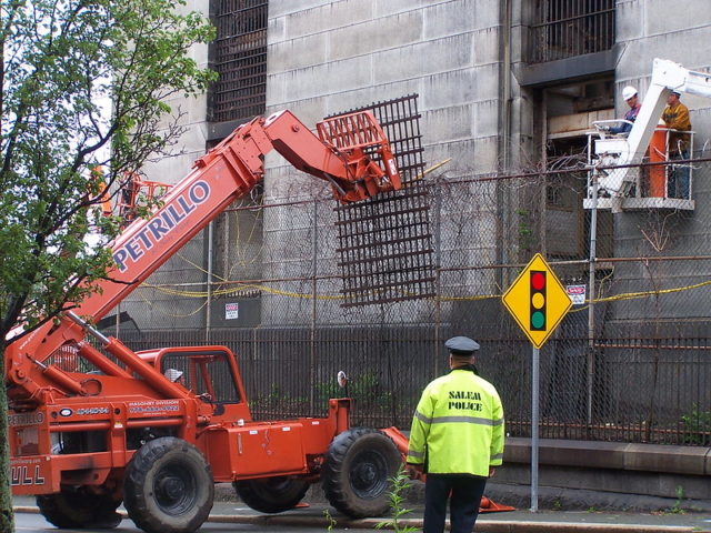 Construction vehicle removing the bars from the Salem Jail. 