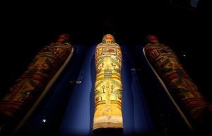 Mummy in a glass case with the reflection on either side.