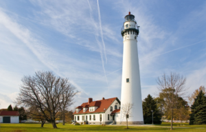 A lighthouse with a house at its base