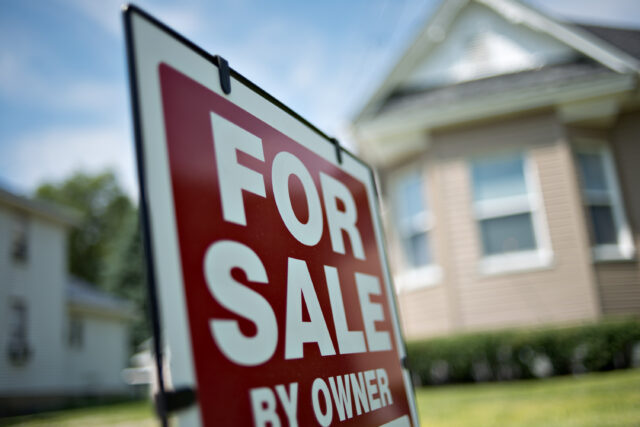 "FOR SALE BY OWNER" sign outside of a house