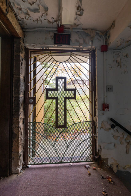 A cross on an iron door.