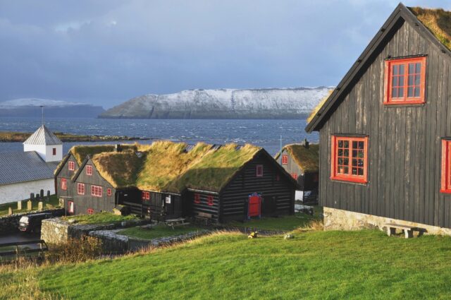 A Viking farmhouse looking out onto water.