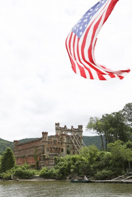 Bannerman Castle on Ellis Island, an American flag flying in the foreground.