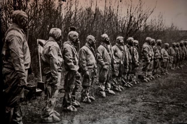 A row of people wearing hazmat suits.