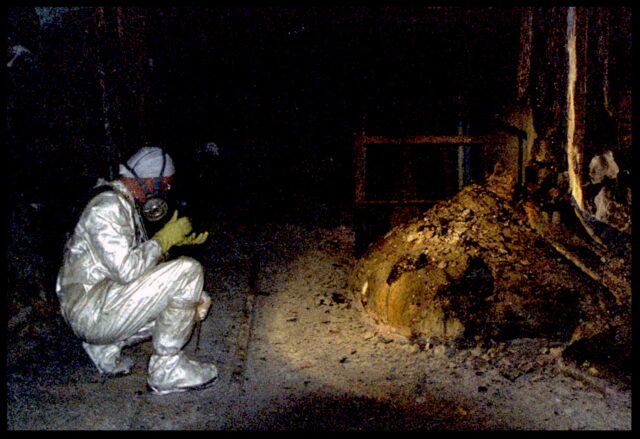 Person photographing elephant's foot at Chernobyl.