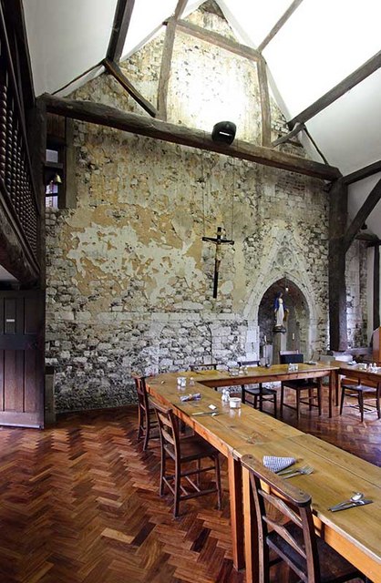 Long dining table in the middle of a large room with high ceilings