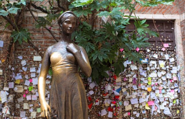 Love notes attached to the wall behind the bronze statue of Juliet, from 'Romeo and Juliet'