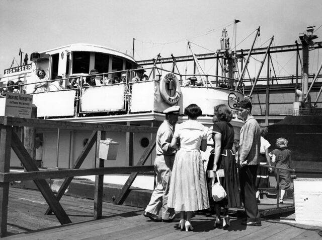 Passengers lined up to board the Sightseer touring yacht