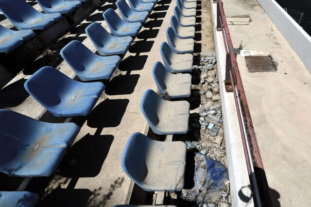 Dirt-covered seats in the bleachers of the Olympic Baseball Stadium in Athens, Greece