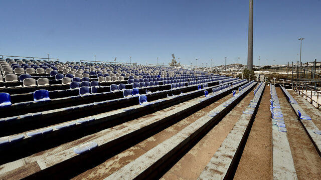 Rows of bleachers covered in dirt at the Olympic Baseball Stadium in Athens, Greece