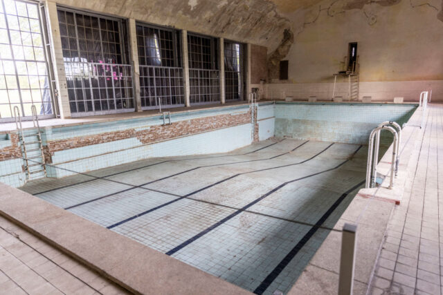 Empty swimming pool in an abandoned room