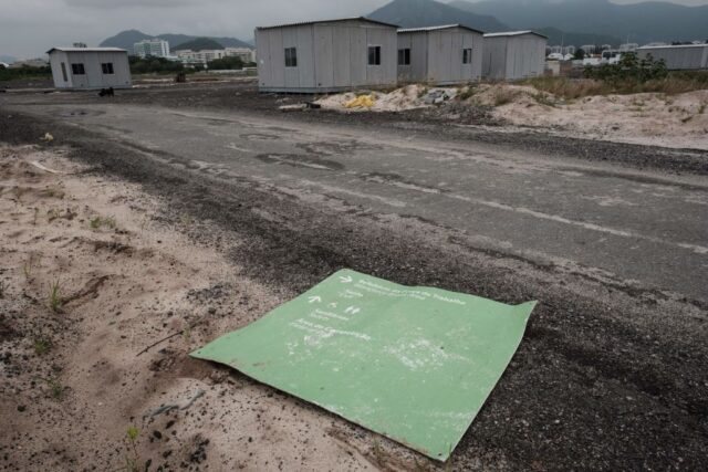 Abandoned prefabricated houses along a roadway