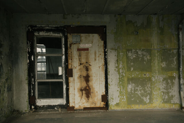 Open doorway cut into a rusted wall