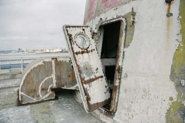 Door hanging off its hinges on the deck of the SS United States