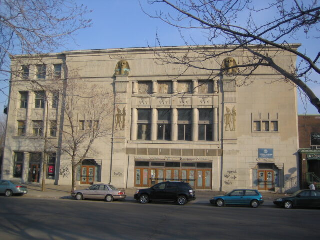 The exterior of an abandoned movie theater.