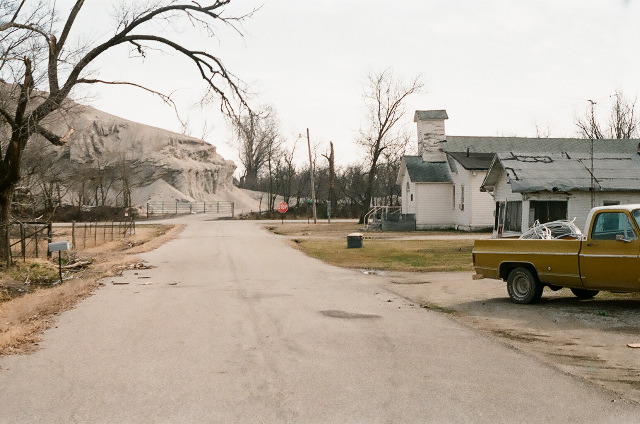 A street with a massive chat at the end in Picher, Oklahoma.