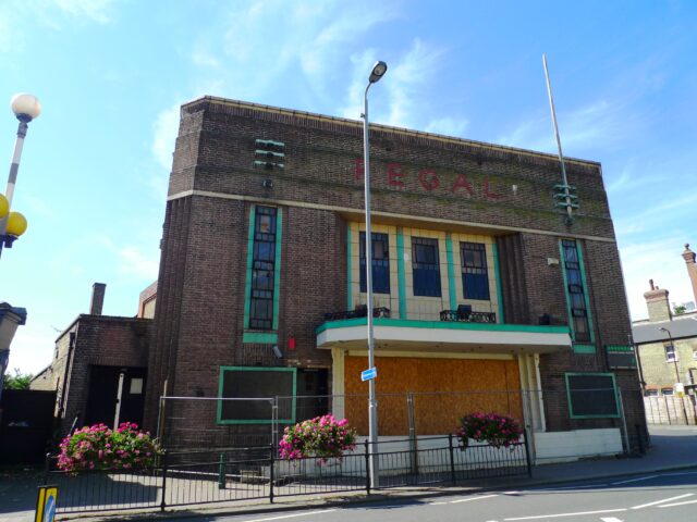 The exterior of an abandoned movie theater.