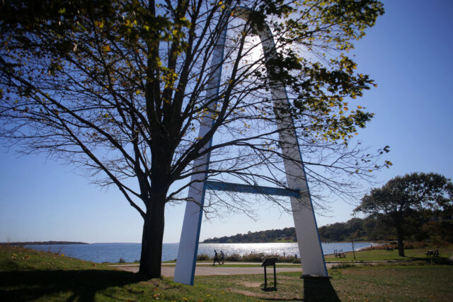 Rocky Point Park arch viewed from behind a tree