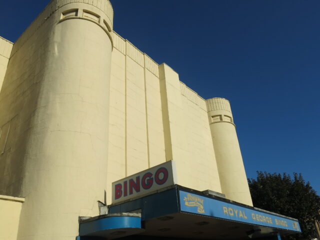 The exterior of an abandoned movie theater.