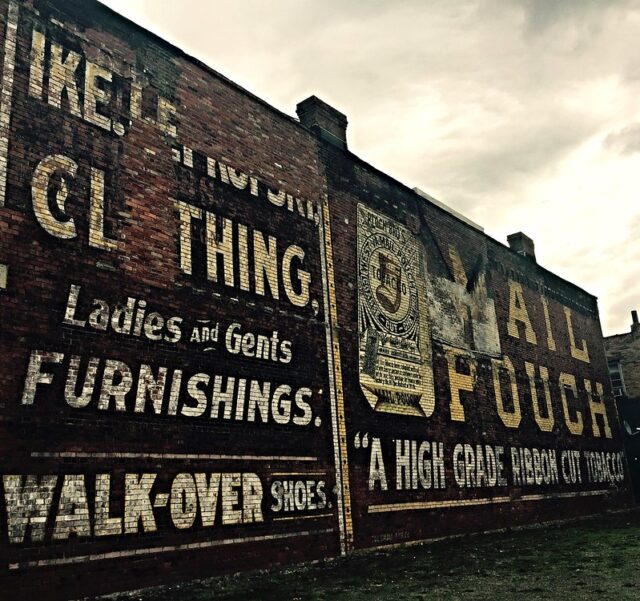 Ghost sign spanning the exterior of two brick walls