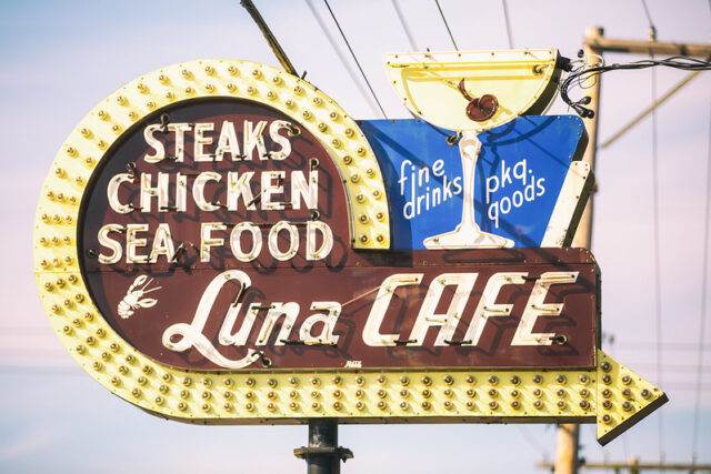 Neon restaurant sign, reading, "STEAKS / CHICKEN / SEA FOOD / Luna CAFE"