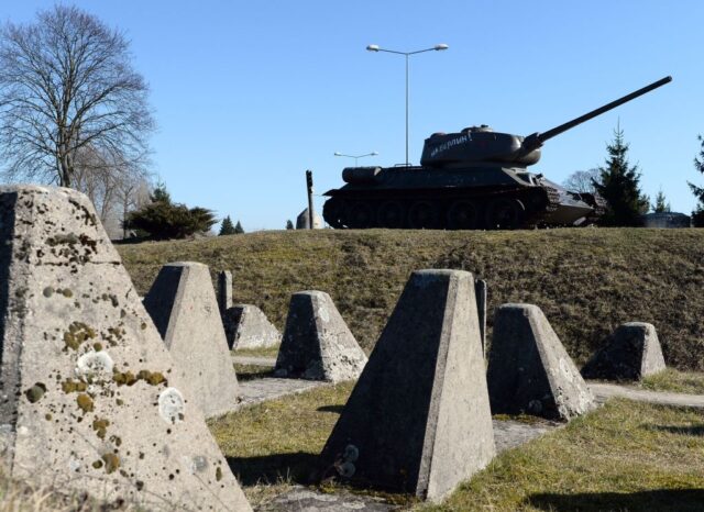 T-34 parked near rows of concrete dragon's teeth