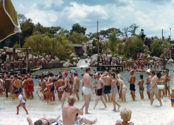 Visitors enjoying a pool and water slide at Disney's River Country