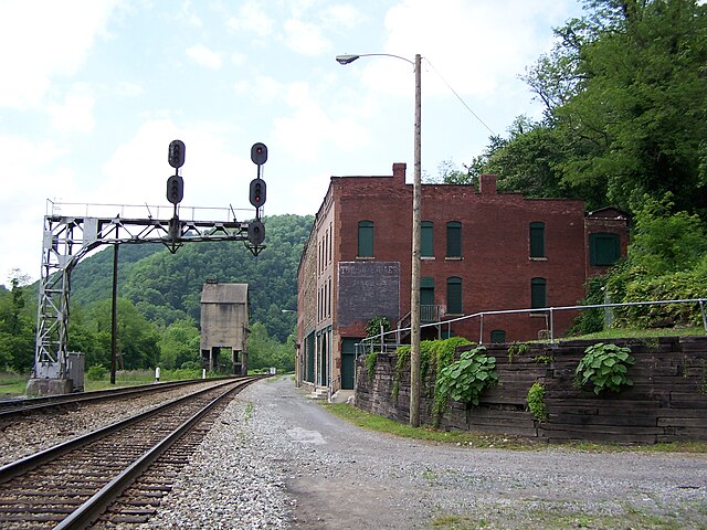 Railroad tracks moving along a brick building